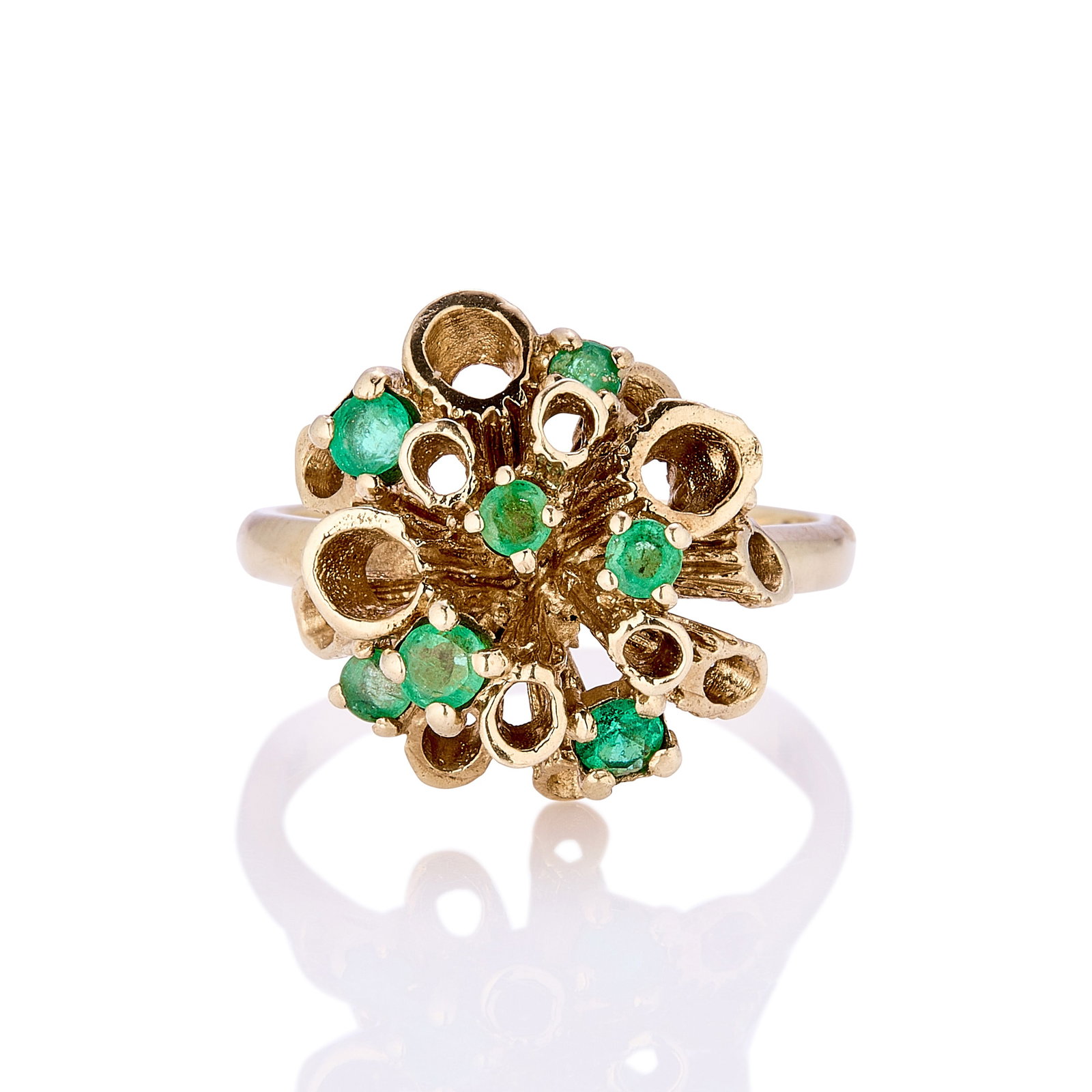 A 9ct gold emerald cluster ring,: A 9ct gold emerald cluster ring, formed as a flower head of vari-sized textured tubular stamens with round emeralds claw set between, hallmarked London 375 1973 (Ring size NΩ; 4.7g) Footnote:
