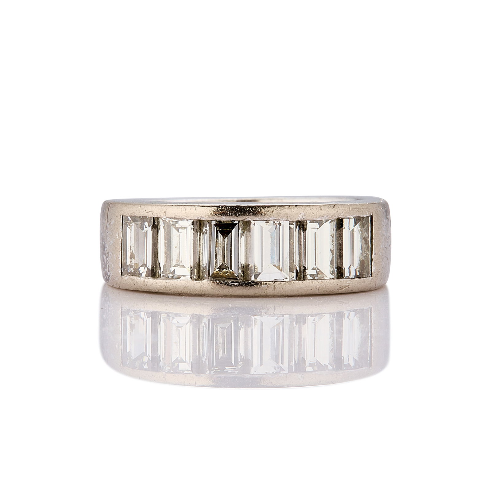 A diamond half eternity ring,: A diamond half eternity ring, the six baguette cut diamonds channel set to a slightly tapered band, total estimated diamond weight approximately 1.30ct, stamped 585, tested as approximately 14ct gold