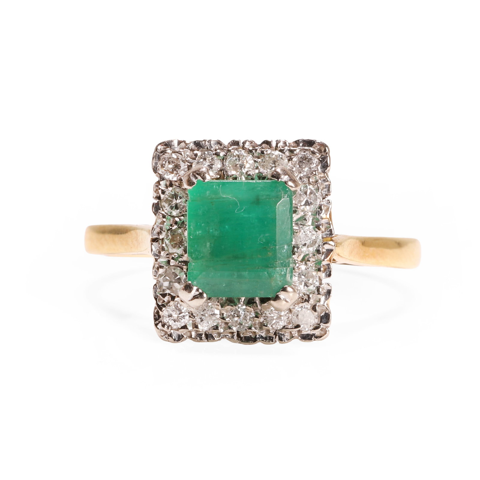 An 18ct gold emerald and diamond cluster ring,: An 18ct gold emerald and diamond cluster ring, the rectangular step cut emerald claw set within a round brilliant diamond surround, one single cut diamond replacement, between chenier shoulders into a
