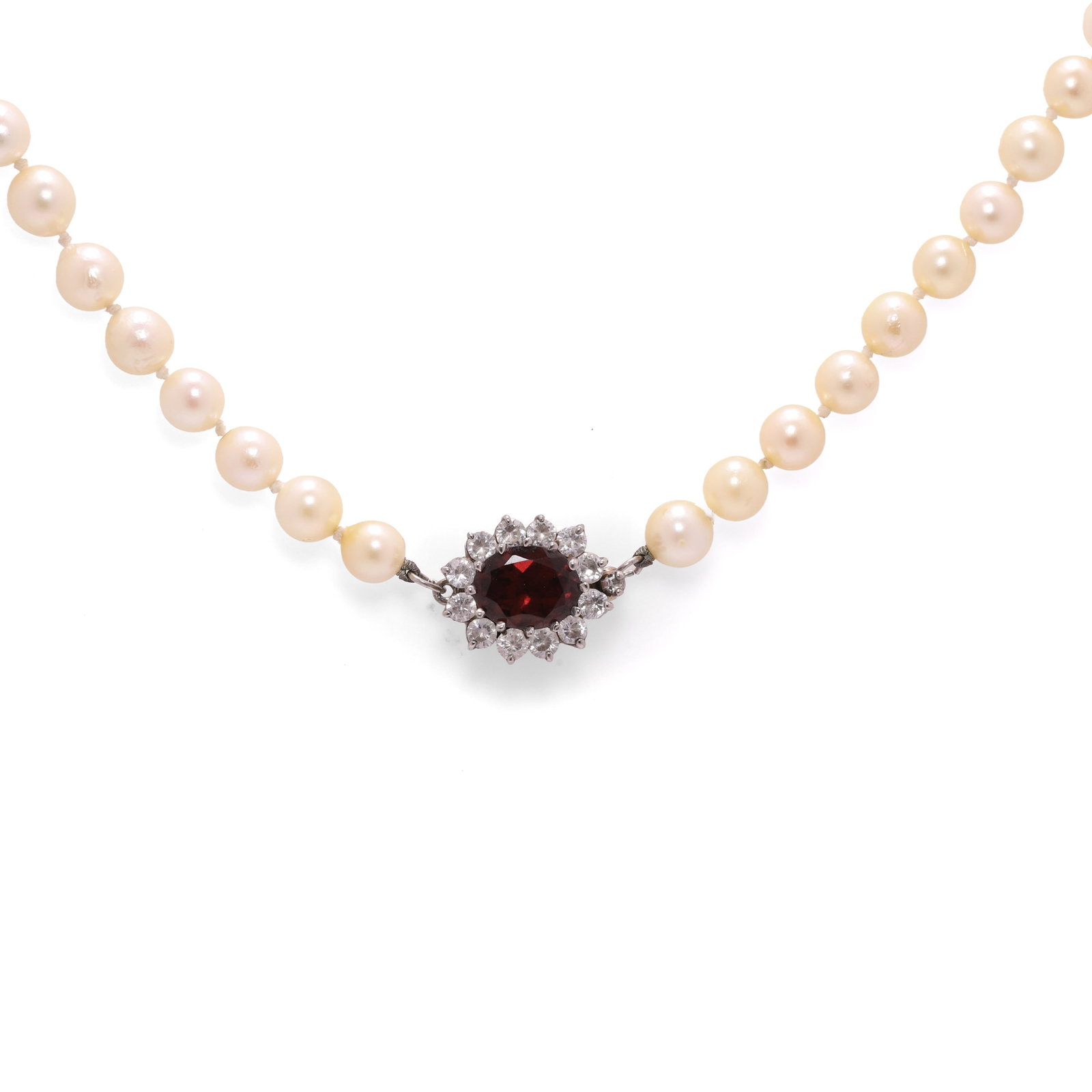 A cultured pearl long necklace,: A cultured pearl long necklace, comprising a single row of off-round cultured pearls, approximately 6.00mm in diameter, to a white metal garnet and white sapphire cluster style clasp (Length 96cm; 49.
