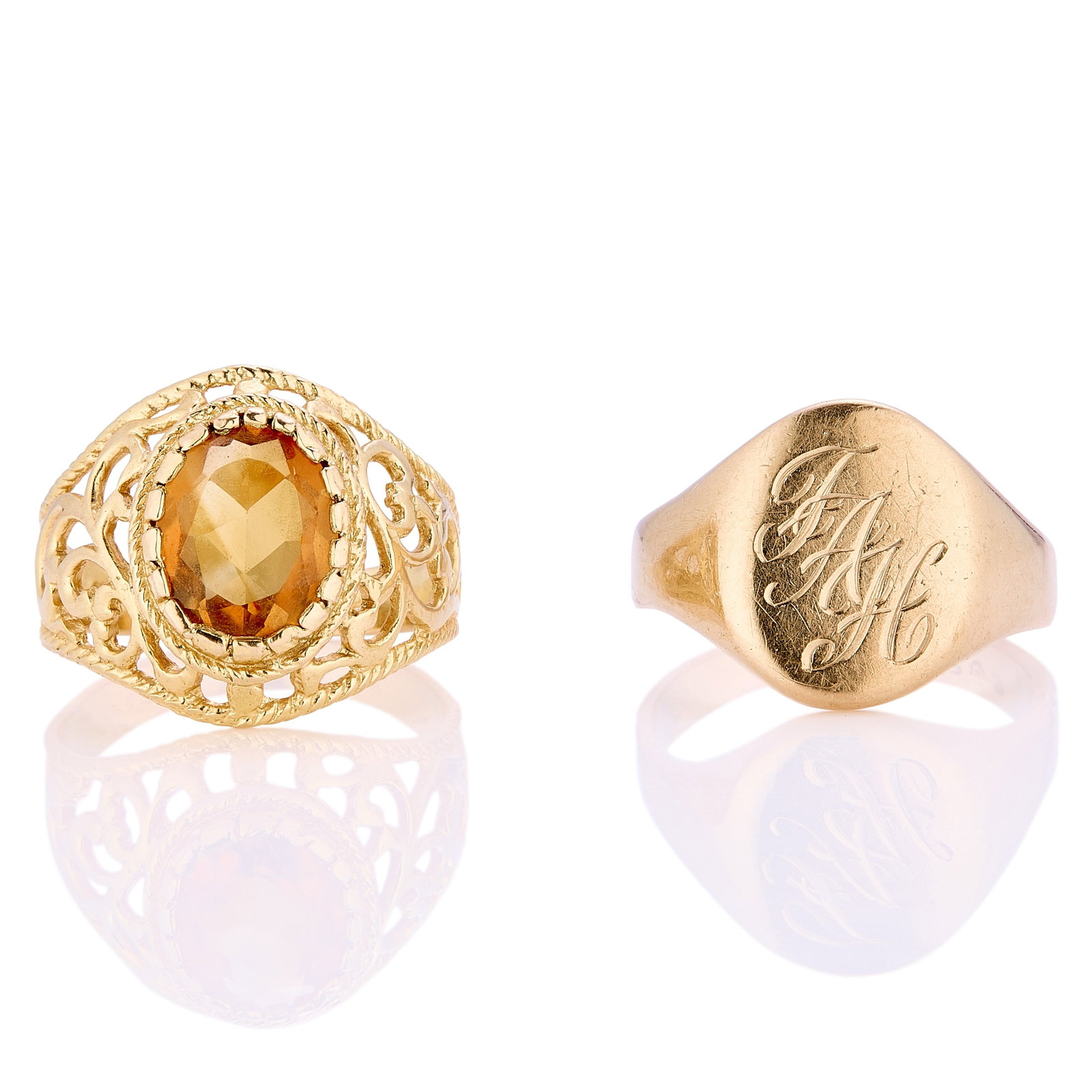 Two 9ct gold rings,: Two 9ct gold rings, comprising a signet ring with engraved monogram to top, London 1969, and a citrine set ring with pierced scroll gallery and shoulders, London 1974 (Total weight 9g) Condition
