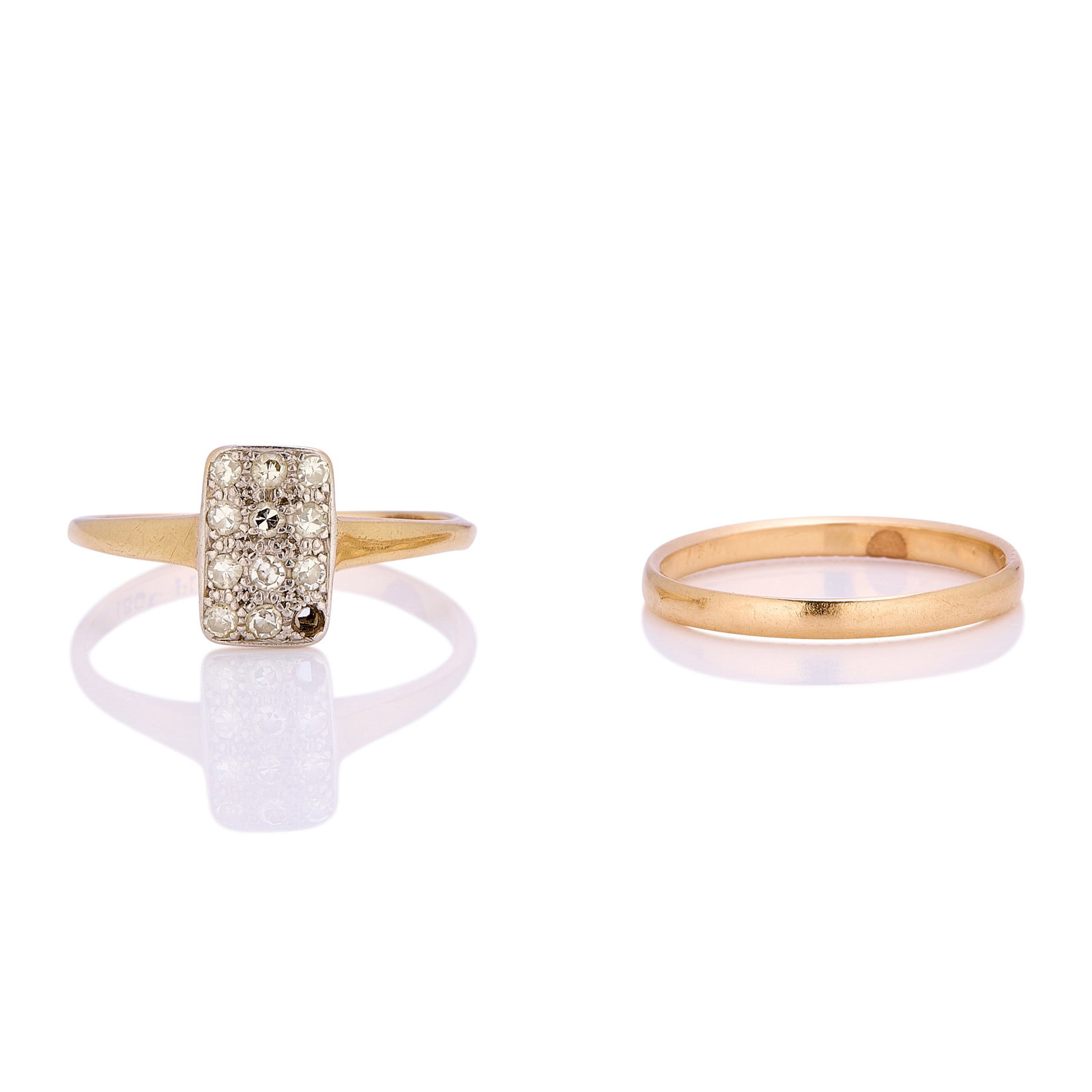 An early 20th-century diamond plaque ring and a band ring,: An early 20th-century diamond plaque ring and a band ring, the plaque ring set with eight cut diamonds, one diamond deficient, stamped 18ct Plat, together with a plain gold band ring with engraving to