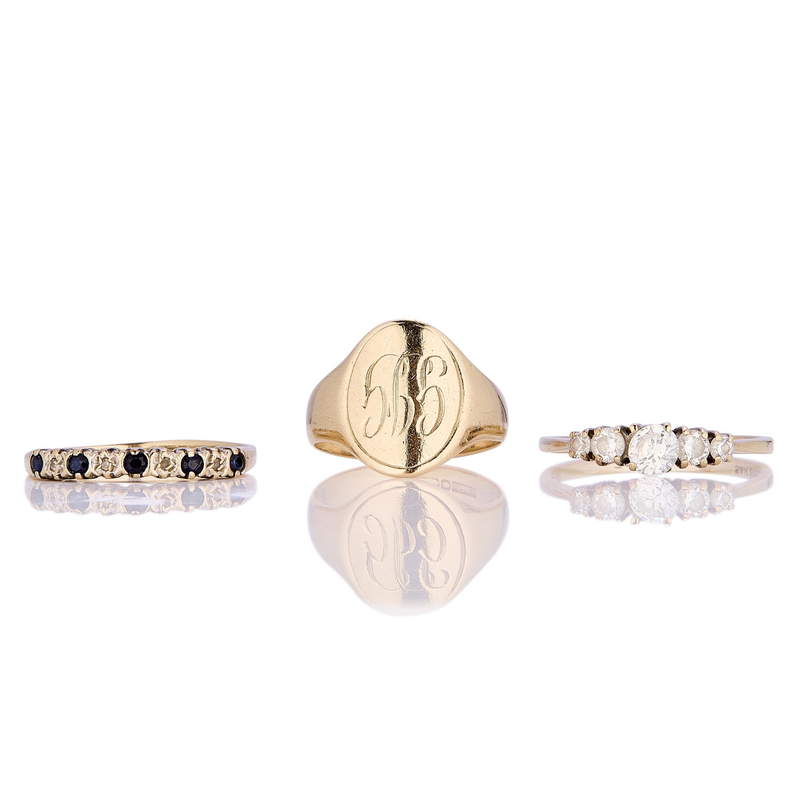 A group of three 9ct gold rings,: A group of three 9ct gold rings, to include a 9ct signet ring with curved oval head inscribed with the monogram GJG, hallmarked 375, marks obscured, a 9ct nine stone sapphire and single cut diamond ri