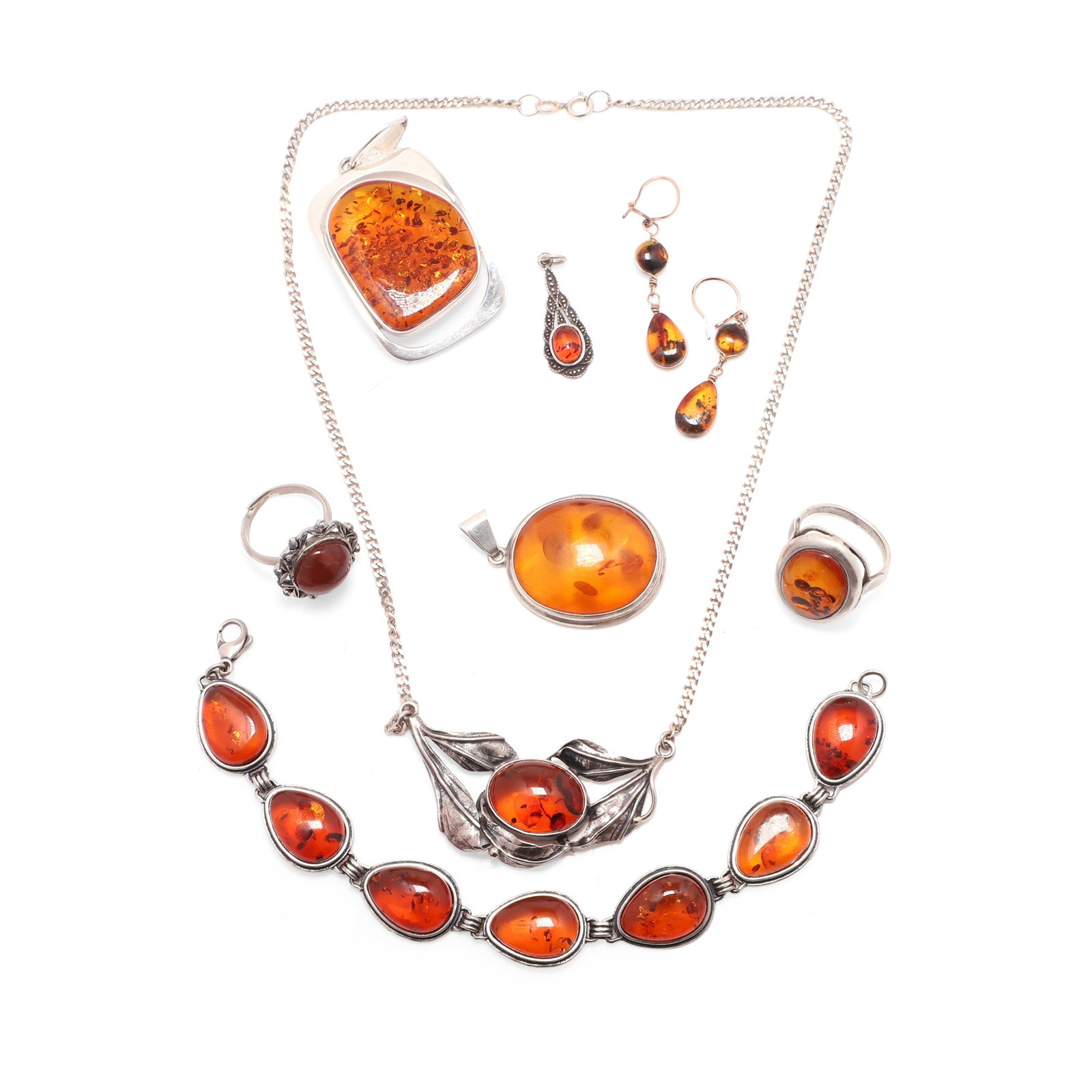 A collection of amber jewellery,: A collection of amber jewellery, to include one bracelet of seven linked pearshaped cabochon amber, one necklace with an oval amber with foliate mount and curb chain, three pendants and a ring each st