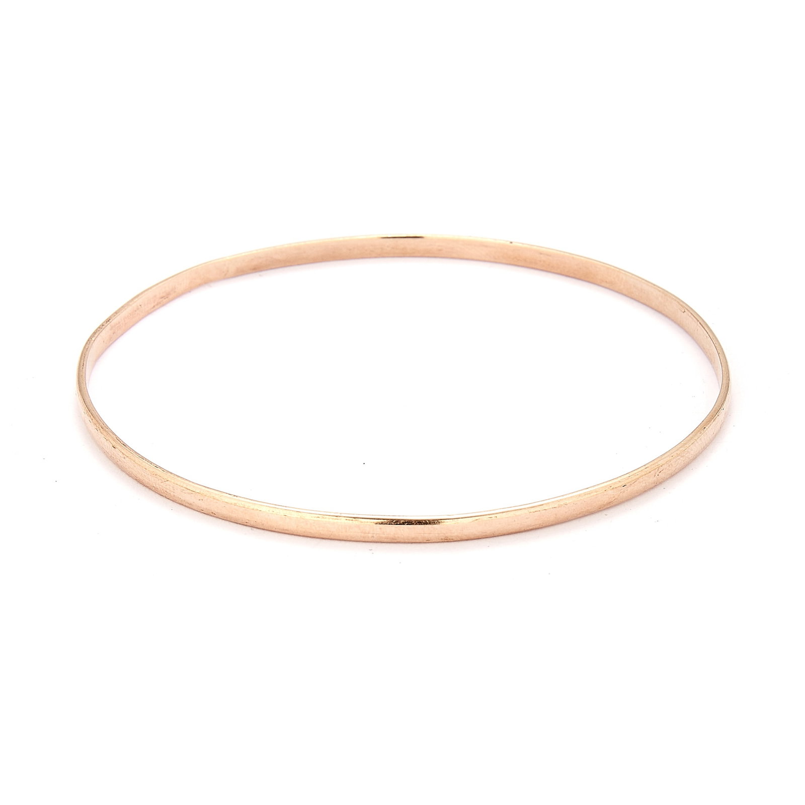 A plain bangle,: A plain bangle, of circular outline, stamped 9ct and tested as approximately 9ct gold (Inner diameter 6.3cm; 6.4g) Condition Report: The hoop is slightly mis shapen. Dimensions: Inner diameter 6.3cm;