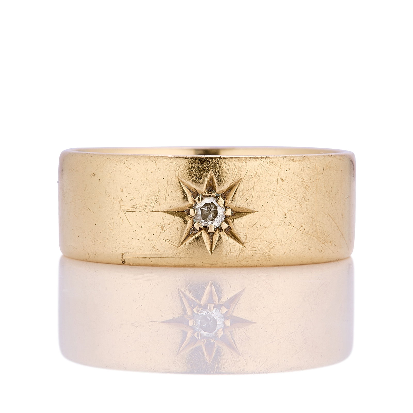 An 18ct gold diamond set band ring,: An 18ct gold diamond set band ring, star set with an old European cut diamond, hallmarked Birmingham 18ct (Ring size RΩ;† 8.4g) Footnote: Buying this diamond ring at auction could save up t