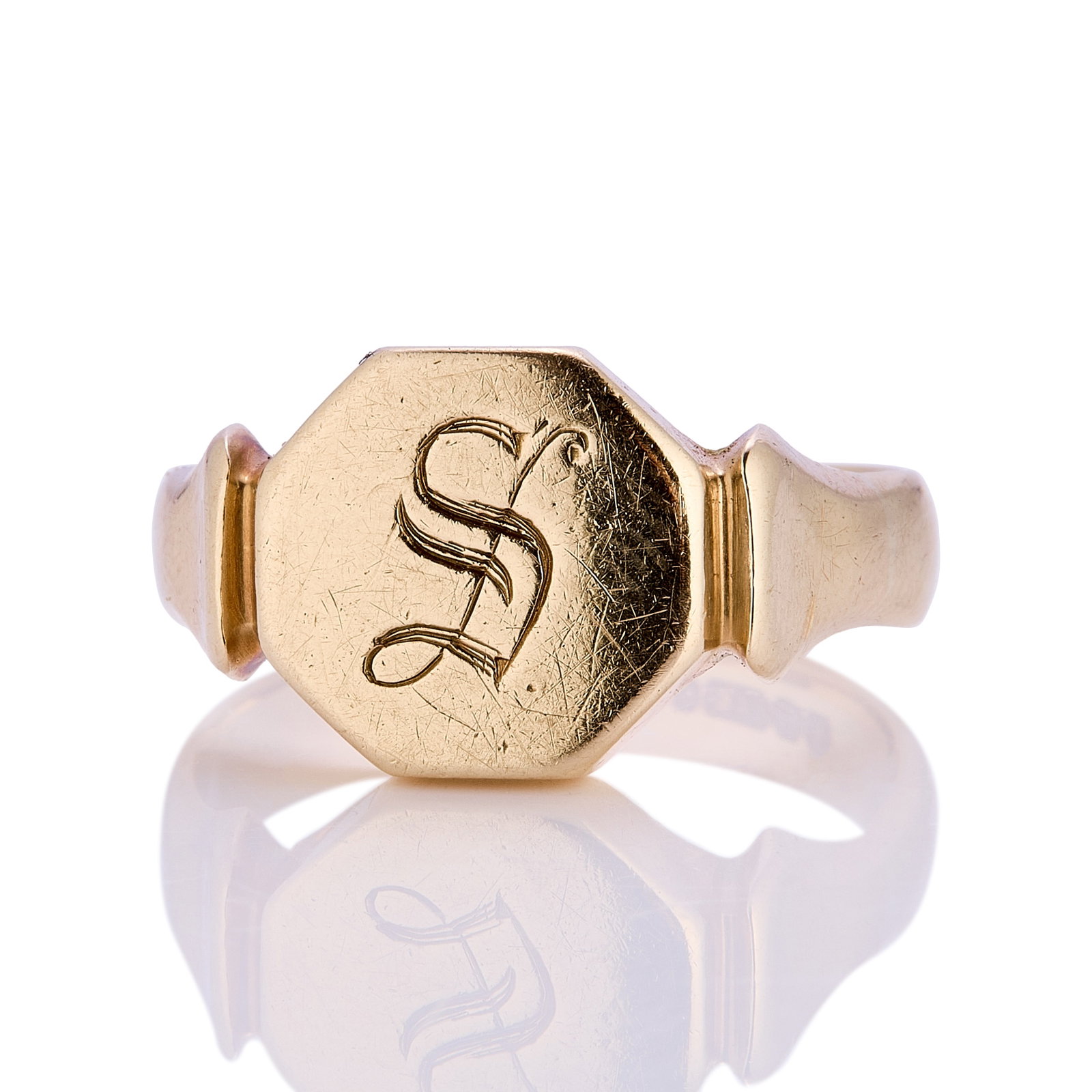 A 9ct gold signet ring,: A 9ct gold signet ring, with octagonal head bearing engraved 'S' with a flared shoulder into a straight 'D' profile band, hallmarked Birmingham, 375, 1948 (Ring size P?; 7.2g) Condition Report: