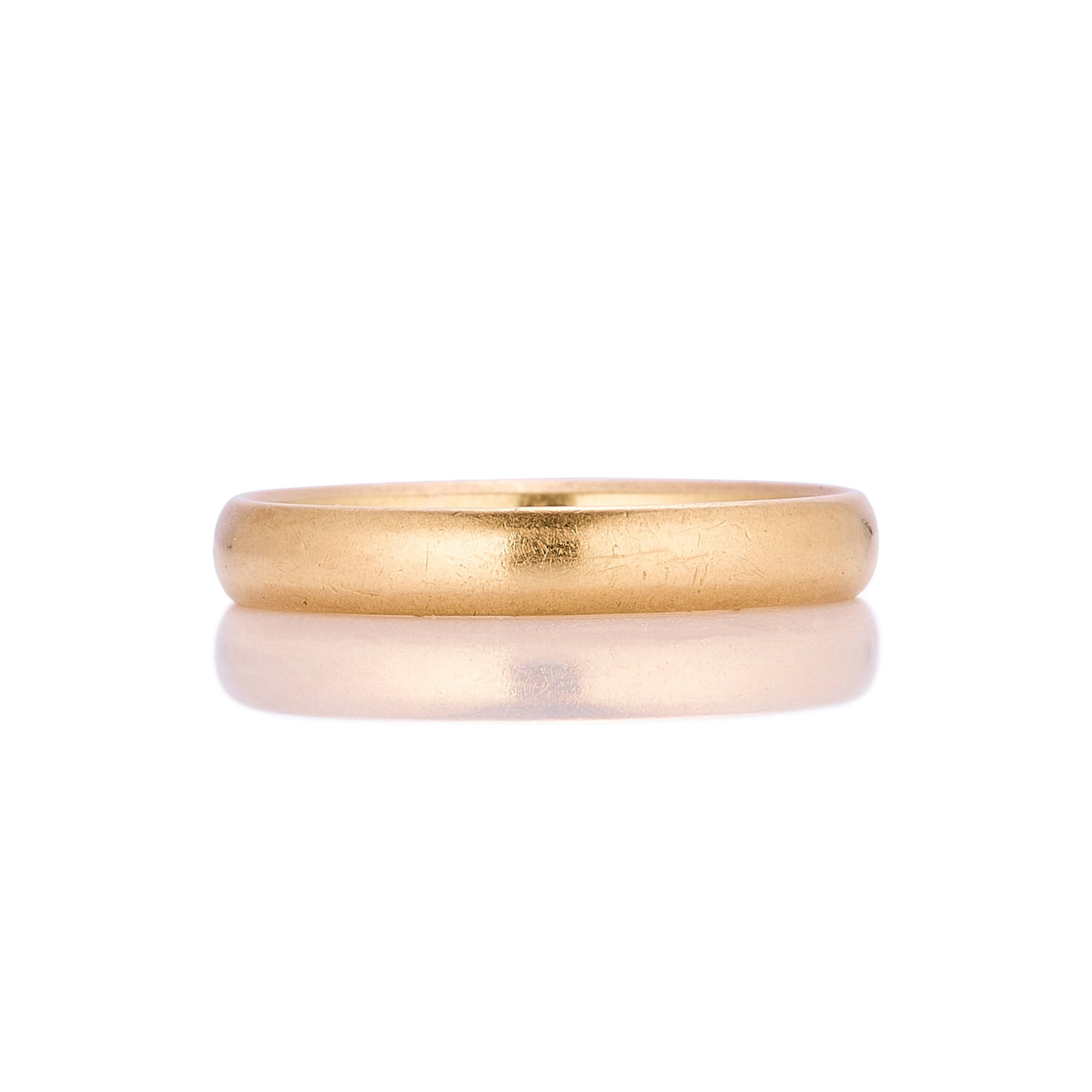 A 22ct gold band ring,: A 22ct gold band ring, hallmarked London, 1959 (Ring size K; 3.1g) Condition Report: Scratches and marks consistent with wear and age. Dimensions: Ring size K; 3.1g