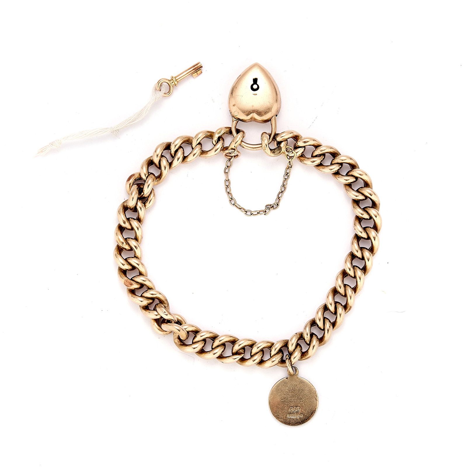 An early 20th century curb link bracelet,: An early 20th century curb link bracelet, with a heart padlock and gold key, stamped 15, tested as approximately 14ct gold, suspending a later 9ct gold St Christopher charm hallmarked 375, London