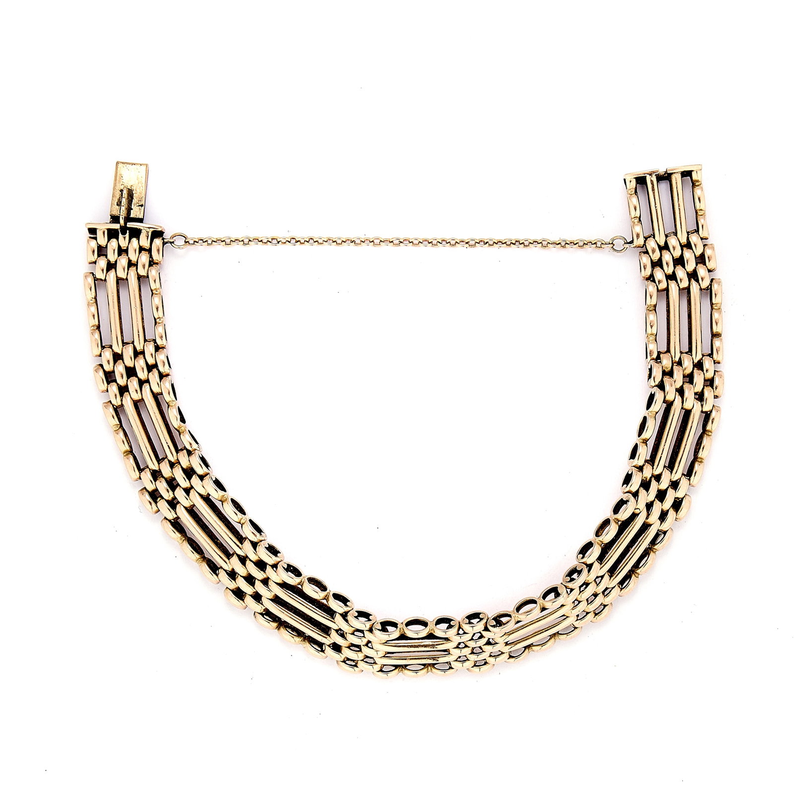 An Edwardian gate bracelet,: An Edwardian gate bracelet, comprising four rows of gate links spaced with pairs of bar links, leading to a box clasp with a safety chain. Unmarked, tested as approximately 9ct gold (Length 19cm;