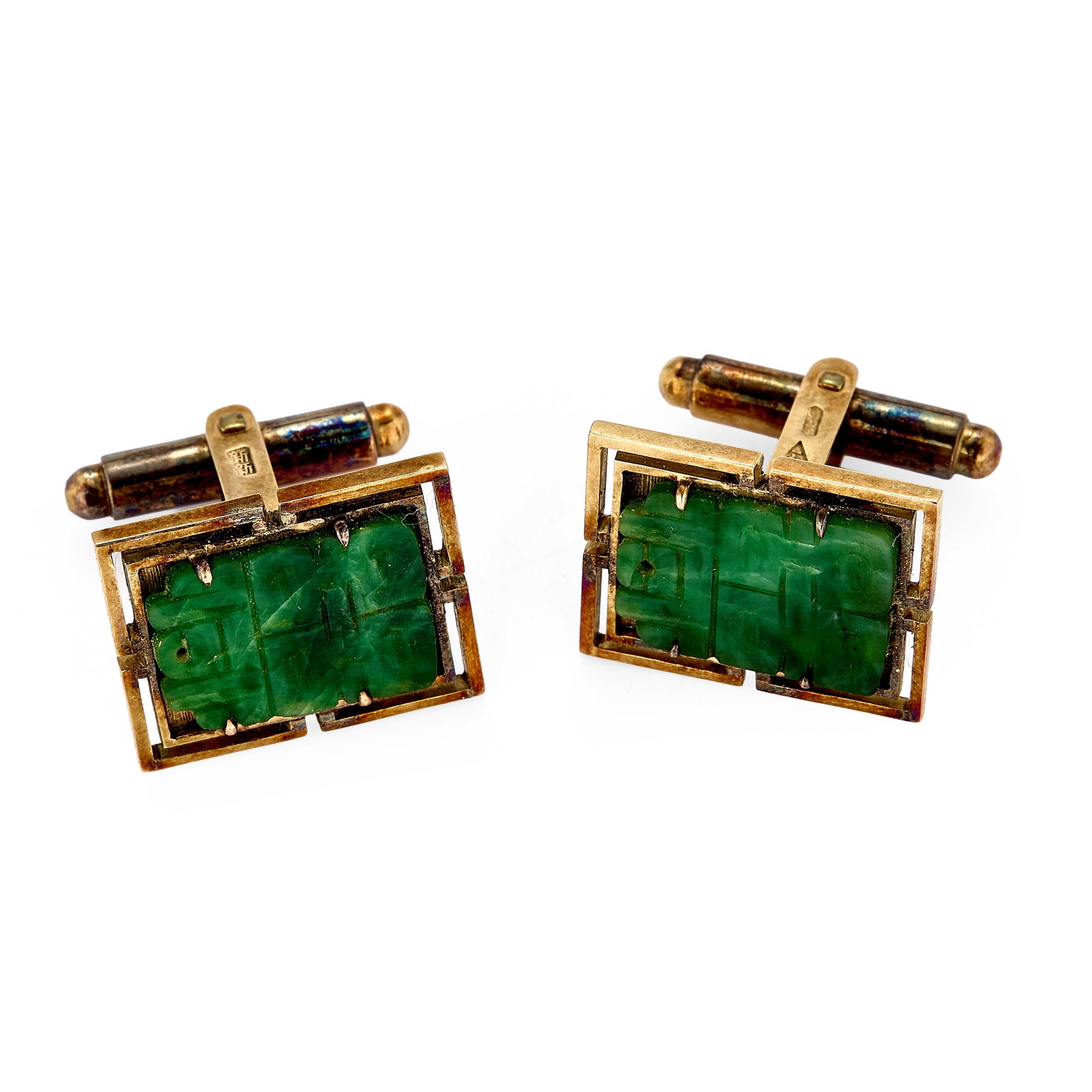A pair of carved jade cufflinks,: A pair of carved jade cufflinks, with applied carved jade double 'Fu' motif, stamped 14k, tested as approximately 14ct gold (Length 2.0cm; width 1.7cm; 15g) Condition Report: The items bear foreign