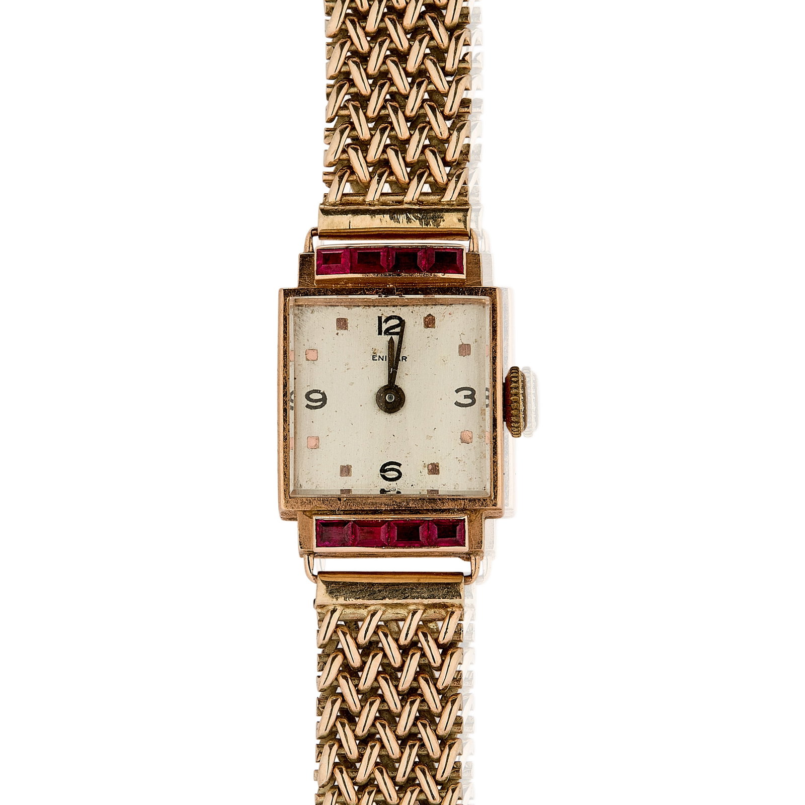 A Swiss gold ladies' Enical mechanical bracelet watch,: A Swiss gold ladies' Enical mechanical bracelet watch, rectangular case, flanked by a line of calibre synthetic rubies above and below, silvered dial signed Enical, snap off case marked 18K 750, Swiss