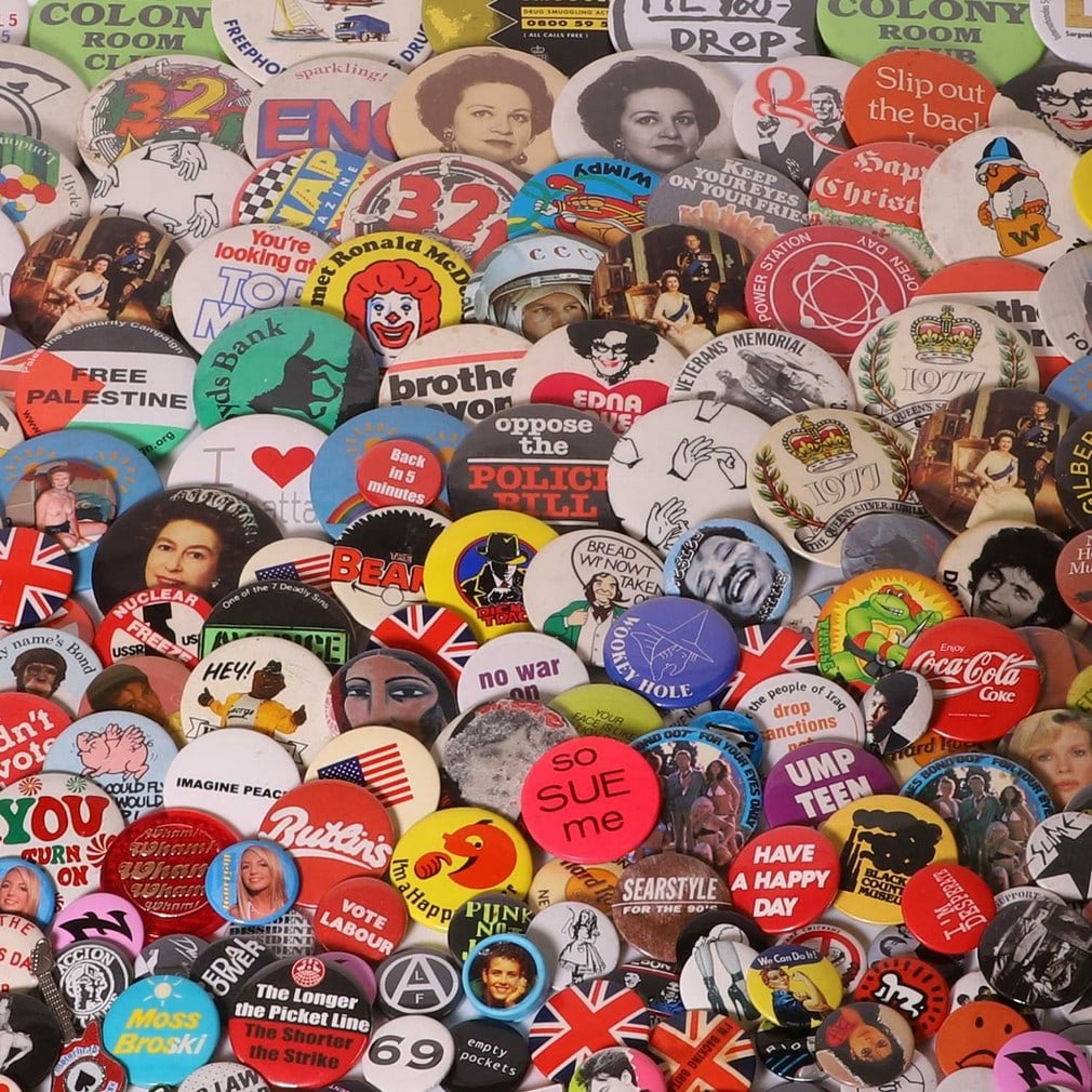 A large collection of popular culture badges,: A large collection of popular culture badges, including film, pop, royalty, advertising and art-related examples (qty.) Condition Report: Please contact the department.
