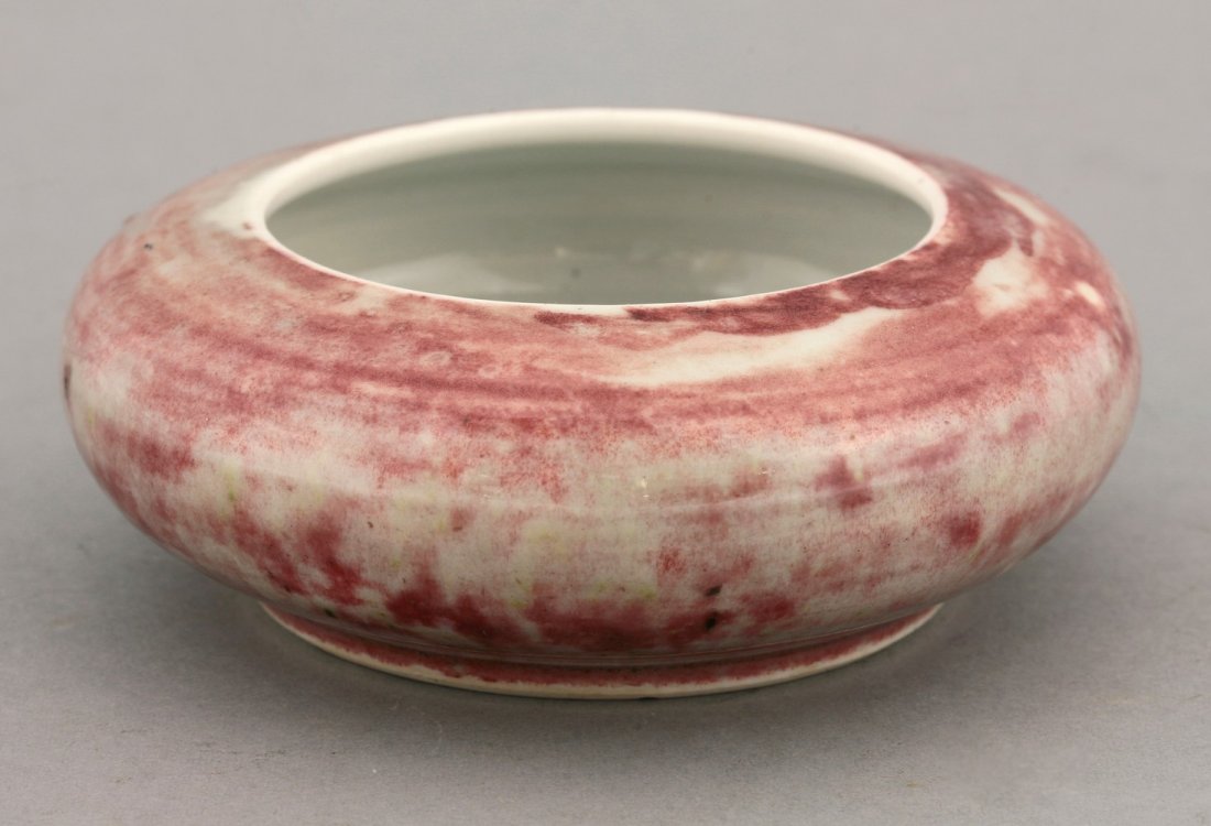 A peach bloom Brush Washer, late 19th century, after a: A peach bloom Brush Washer, late 19th century, after a Kangxi original, the depressed body in shades of magenta and grey, four character mark of Kangxi in underglaze blue, 12cm
