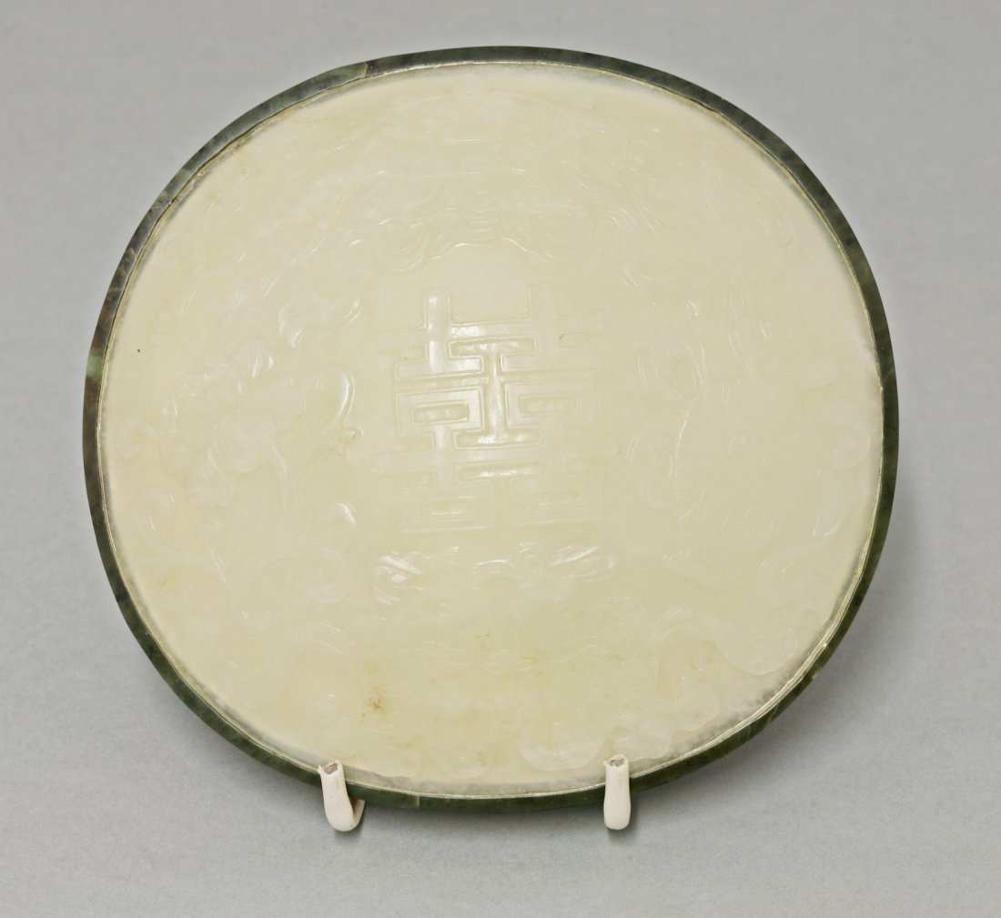 A Box and Cover, 18th and 20th century, the domed cover: A Box and Cover, 18th and 20th century, the domed cover probably originally from a rui sceptre, carved with a double xi within large twin fish, peony, vase and hat, set on a well engraved soapstone ba