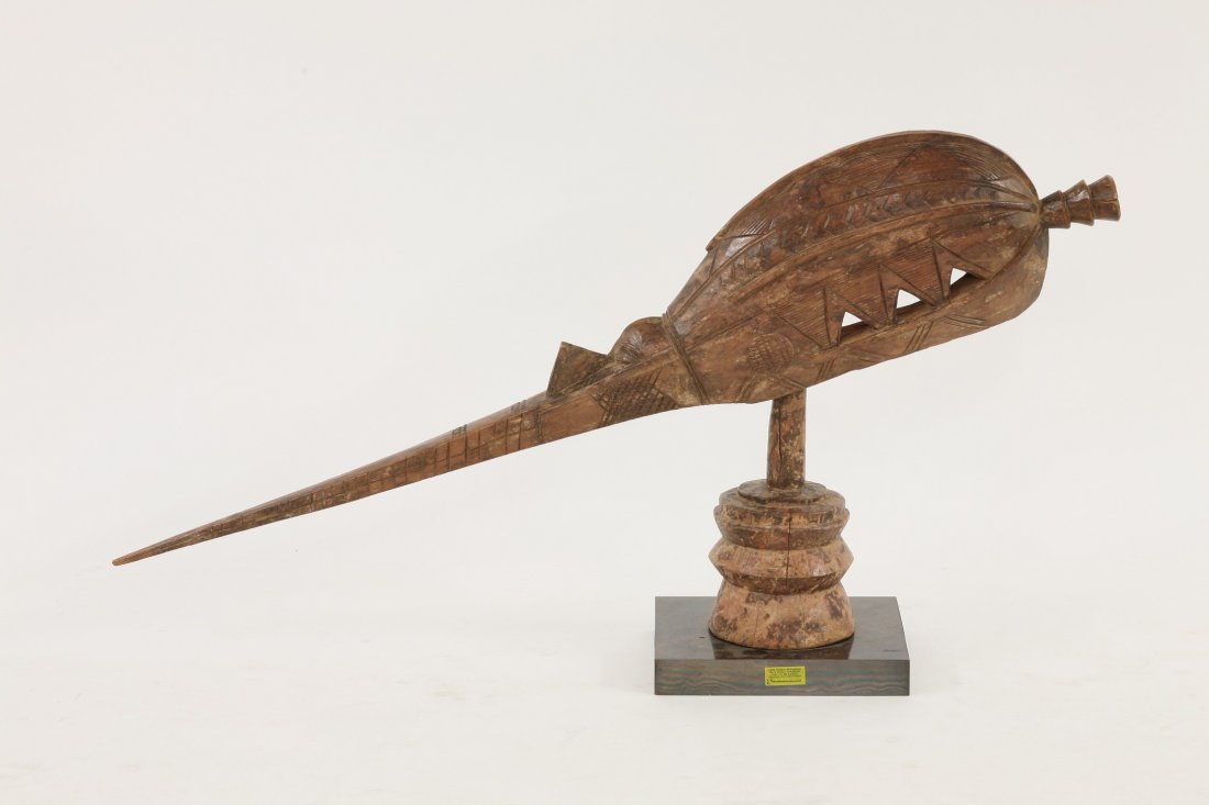 A Baga tribe altar head or shrine piece, Guinea, West: A Baga tribe altar head or shrine piece, Guinea, West Africa with carved cross-hatched decoration, on a turned stand, 110cm long For a similiar shrine piece, see Frederick Lamp 'Art of the Baga' Prest