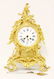 A rococo-style gilt bronze mantel clock, the enamel