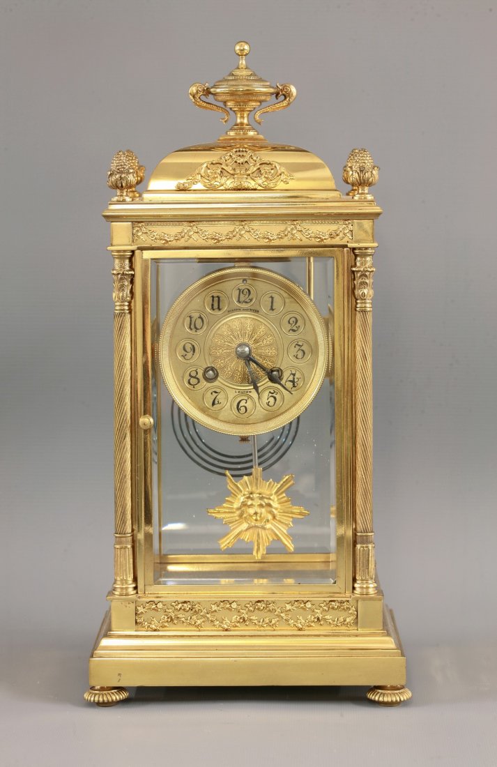 A French four glass mantel clock, c.1878, Mappin &: A French four glass mantel clock, c.1878, Mappin & Webb, the eight day twin barrel movement by L. Pl. Jappy & Co., striking on a gong, the gilt brass case with urn finial, pine cone corner finials and