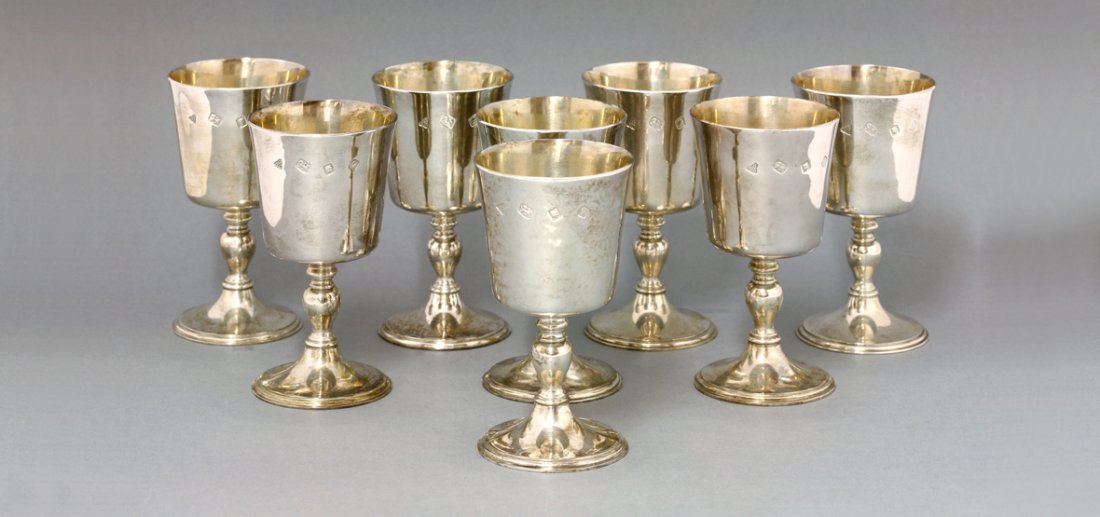 A set of eight silver goblets, by Garrard & Co. Ltd.,: A set of eight silver goblets, by Garrard & Co. Ltd., London 1971, the tapering cylindrical bowls supported on knopped baluster stems terminating in spreading circular feet, 12.5cm high, 44oz