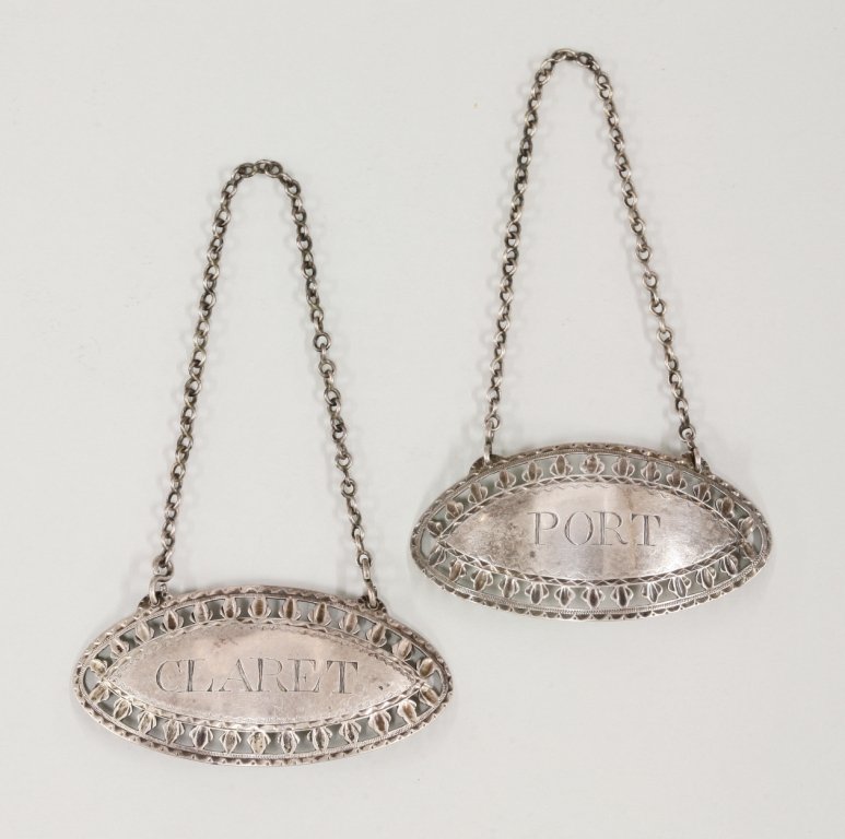 A pair of large George III Irish silver wine labels, by: A pair of large George III Irish silver wine labels, by George Nangle, Dublin c.1795, of navette form with pierced leaf borders and brightcut decoration surround, incised 'Port' and 'Claret', 6.5cm wi