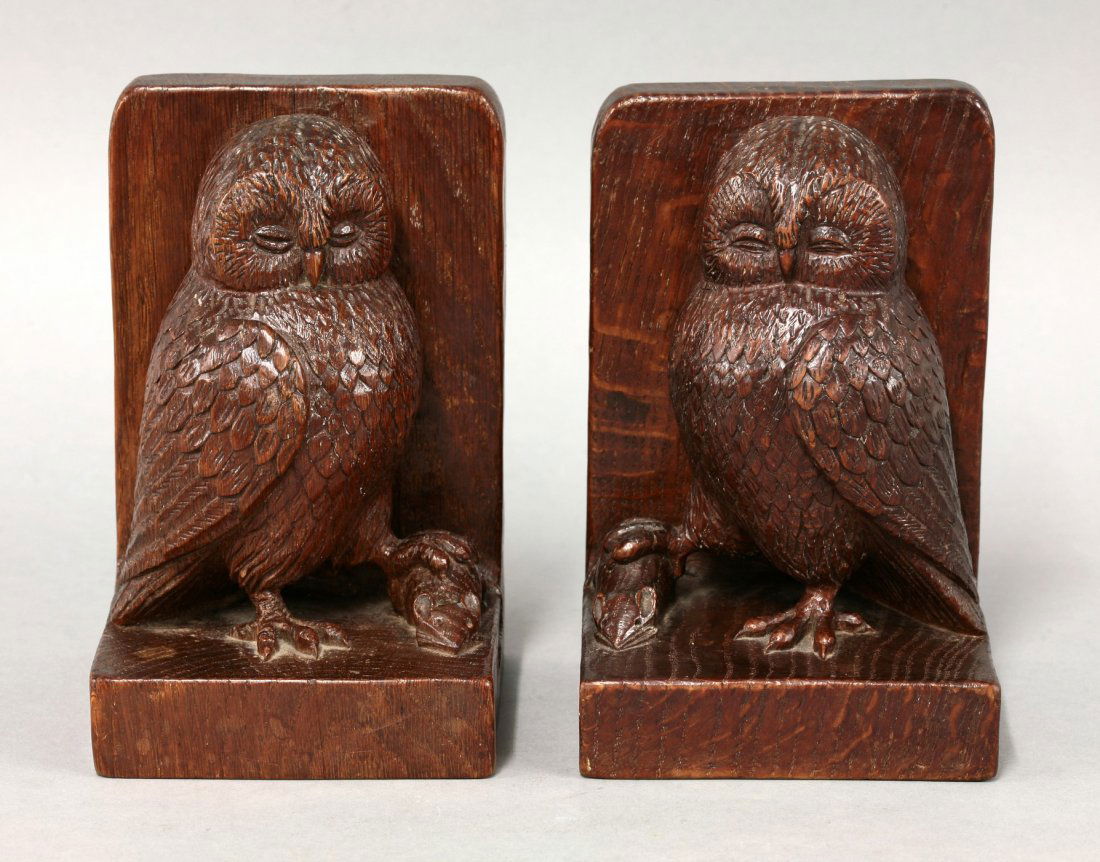 A pair of Robert 'Mouseman' Thompson oak bookends, each: A pair of Robert 'Mouseman' Thompson oak bookends, each carved with owls holding a mouse in their talons, 15cm high (2)