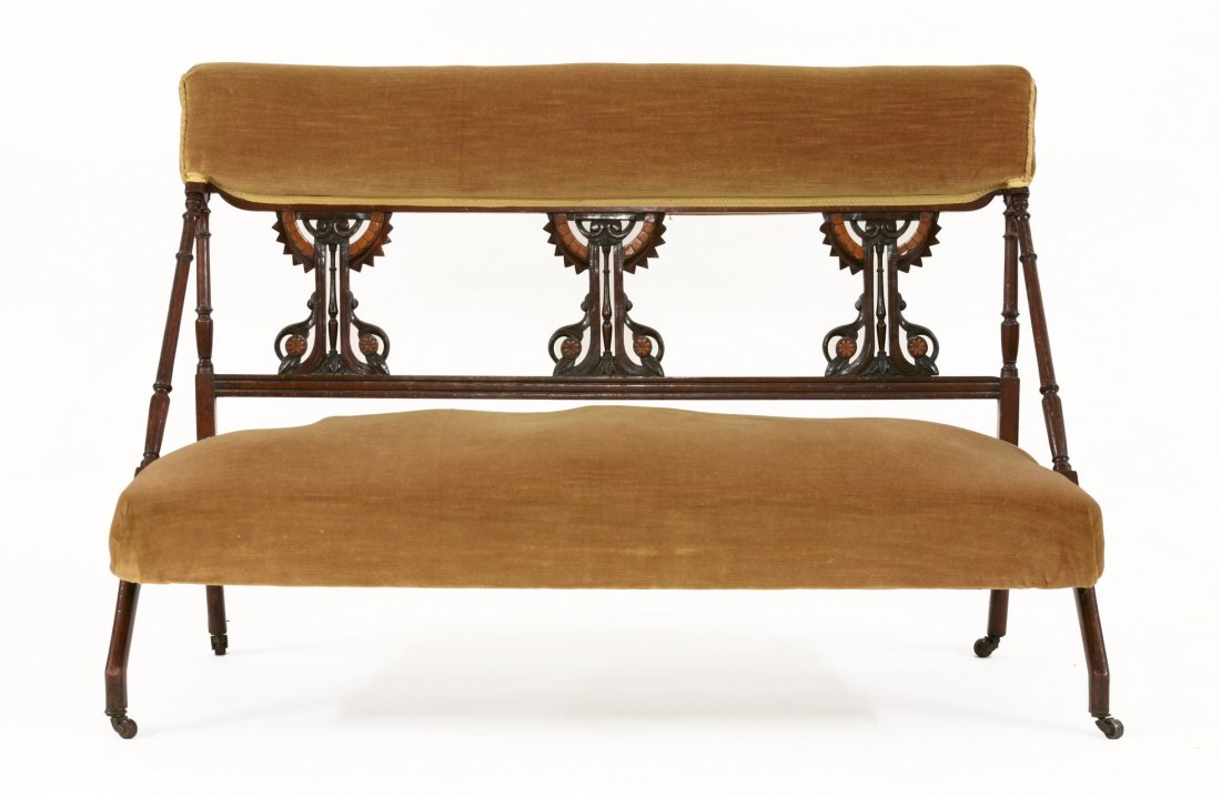 An Aesthetic settee, possibly after a design by Dr: An Aesthetic settee, possibly after a design by Dr Christopher Dresser, with three stylised splats, and yellow upholstery, the ends with angular arms and front legs, 127cm long 64cm deep 78cm high