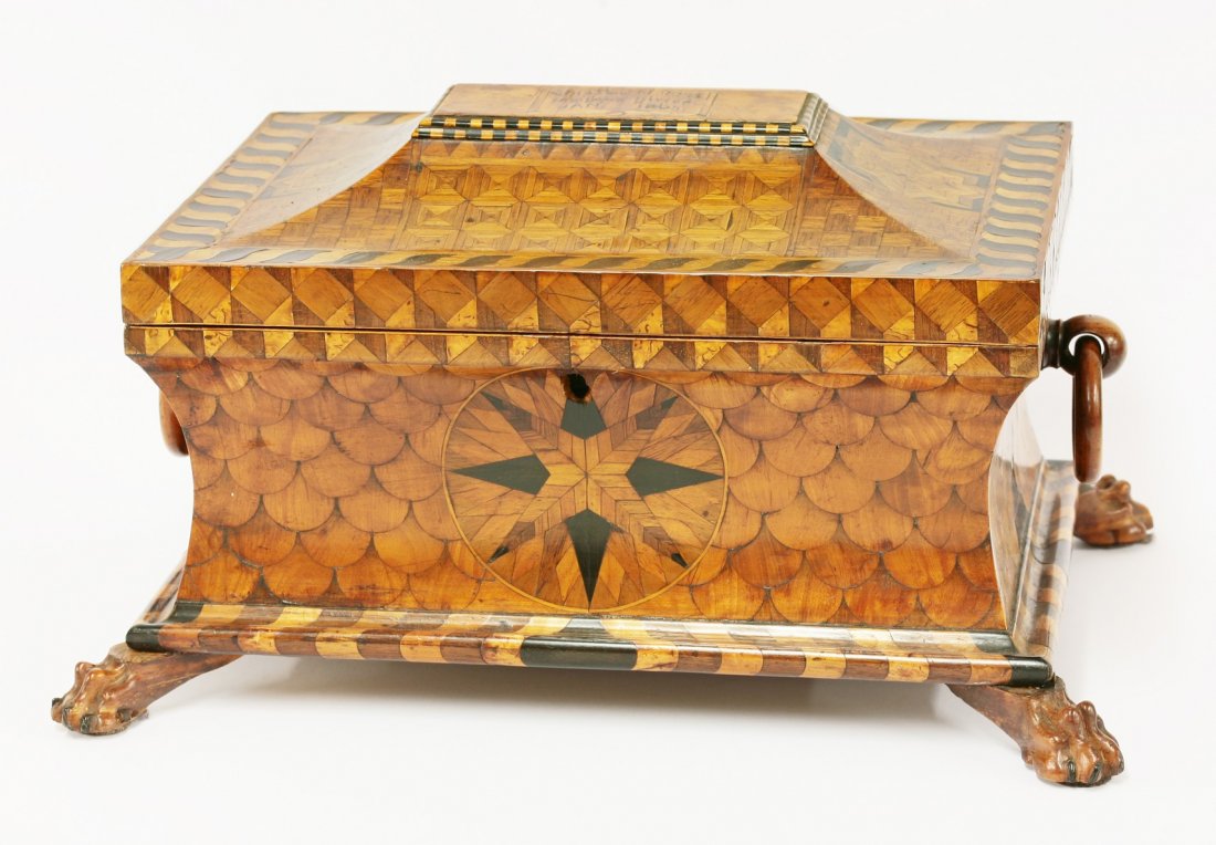 A Victorian parquetry box, the lid with a raised panel: A Victorian parquetry box, the lid with a raised panel inscribed 'This box composed of 2255 pieces Jan 1865(?)', with two ring handles and paw feet, 39cm wide 30cm deep 23cm high
