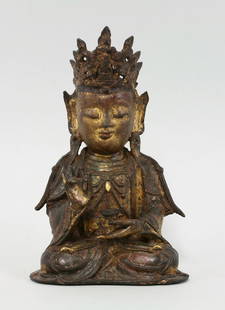 A bronze Guanyin, late Ming dynasty, the figure seated: A bronze Guanyin, late Ming dynasty, the figure seated holding a cup, one hand raised in vitarkamudra (teaching gesture) and wearing a crown with Buddha, traces of red and green paint and gilding, wea