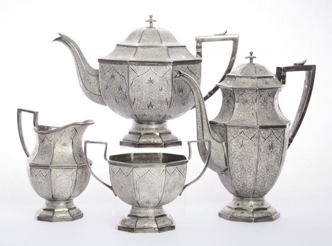 An Indian silver four-piece tea and coffee service,: An Indian silver four-piece tea and coffee service, Kashmir, c.1930, of octagonal baluster form with waisted necks on octagonal feet, decorated with foliage, 63oz Provenance: the vendor's aunt acquire