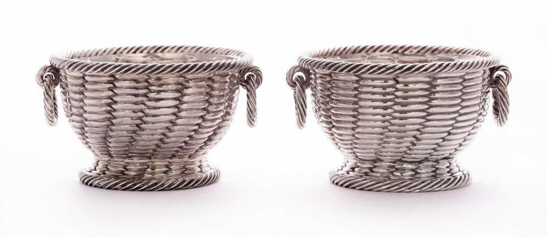A pair of Victorian silver salts, by Robert Hennell: A pair of Victorian silver salts, by Robert Hennell III, London 1855/6, modelled as wicker baskets with ropework ring handles, 7.5cm diameter, 6oz See 'Hennell Silver Salt Cellars 1736 to 1876', by Pe