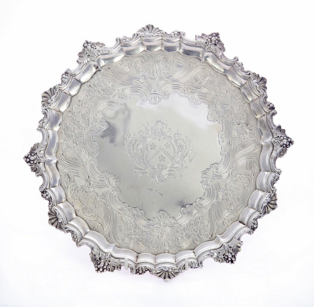 A George II silver salver, by John Robinson II, London: A George II silver salver, by John Robinson II, London 1745, of shaped circular form with vine and shell border on three paw feet, the centre engraved with coat of arms within rocaille cartouche and s