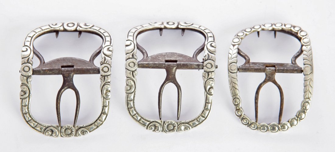 A pair of George III silver and steel buckles, possibly: A pair of George III silver and steel buckles, possibly by David Chatterton, London c.1788, of oblong form, with flowerhead and leafy scroll borders, initialled, 6.5cm long, and another single buckle,