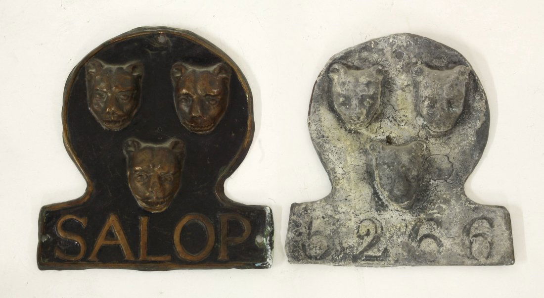 A pair of Salop (Shropshire) fire marks, both: A pair of Salop (Shropshire) fire marks, both constructed from different materials, one pressed out of tin with Salop beneath, another cast, having 5266 beneath, 20 x 20cm (2)