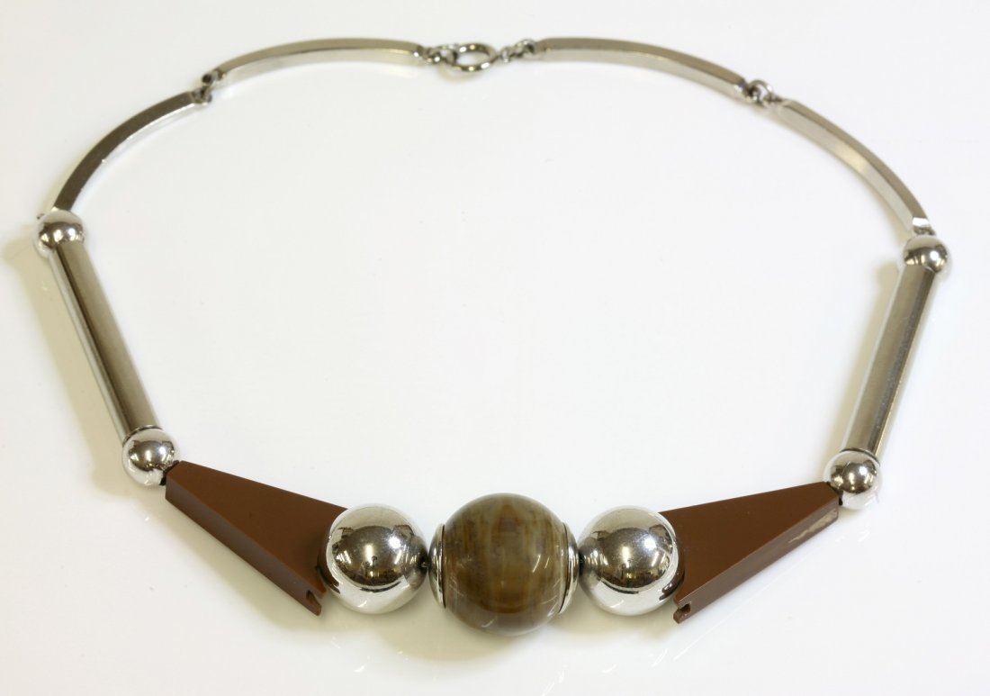 A German Art Deco necklace, attributed to Jakob Bengel,: A German Art Deco necklace, attributed to Jakob Bengel, c.1930, a centrepiece composed of a mottled brown Galalith bead between chrome plated beads and tapering brown Galalith sections, to chrome plat