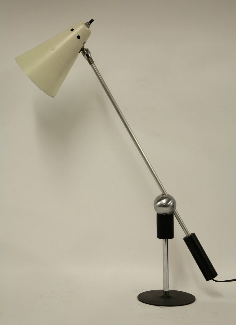 A polished chrome and aluminium desk lamp, designed by: A polished chrome and aluminium desk lamp, designed by Yasha Heifetz and Gilbert Watrous in the 1950s, with a cream powder-coated shade and magnetic ball swivel pivot, 57cm high