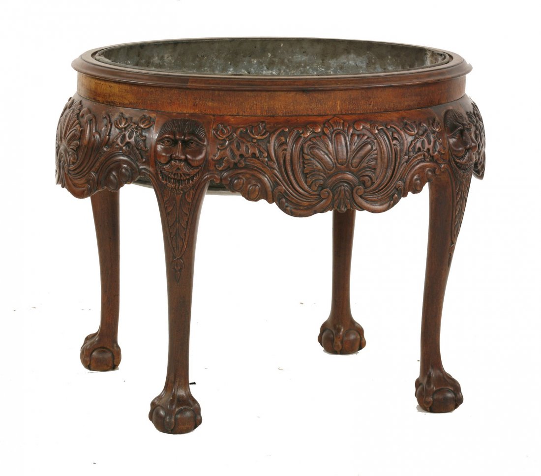 A George I style wine cooler/jardinière, c.1900,: A George I style wine cooler/jardinière, c.1900, possibly Irish, with carved apron and mesh decoration on four claw and ball legs, with metal liner, 81cm long 62m wide 63cm high