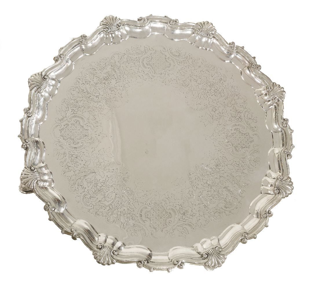 A large Victorian silver salver, by Robert Hennell,: A large Victorian silver salver, by Robert Hennell, London 1869, also with cross-hatched arrows mark, of shaped circular form with shell and scroll border, engraved with a frieze of flowers and hatche