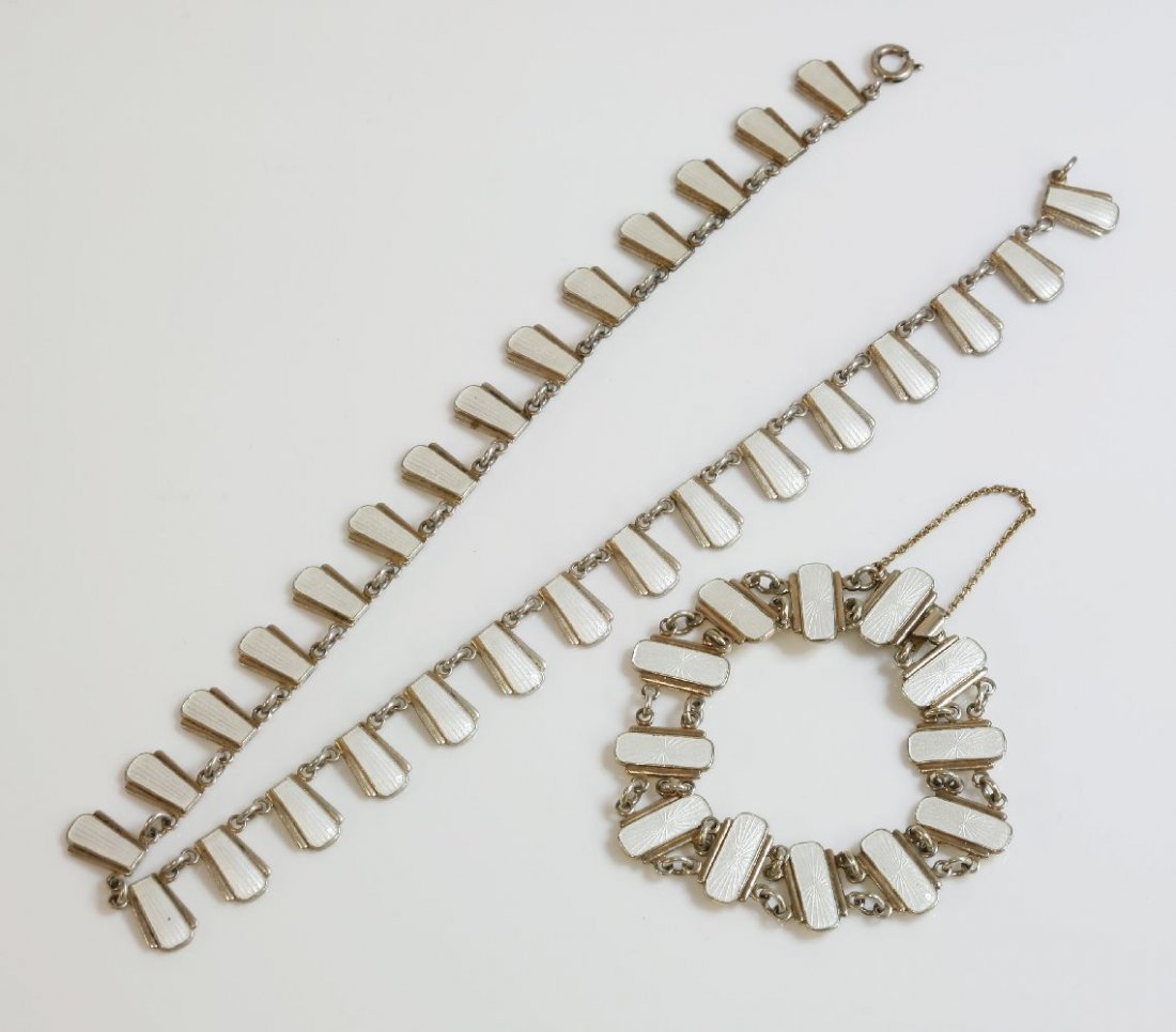 A Danish sterling silver enamel fringe necklace and: A Danish sterling silver enamel fringe necklace and matched bracelet, by Volmer Bahner & Co. 1962-1987. The necklace composed of a series of keystone plaques, with a white guilloch‚ enamel band to t