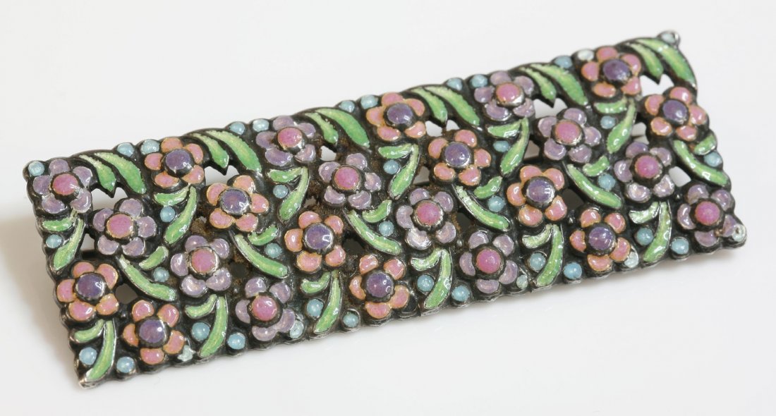 An Arts and Crafts silver enamel plaque brooch,: An Arts and Crafts silver enamel plaque brooch, attributed to Bernard Instone. A rectangular plaque brooch composed of a series of smaller plaques with enamel flower heads and leaves in pink, lilac, s