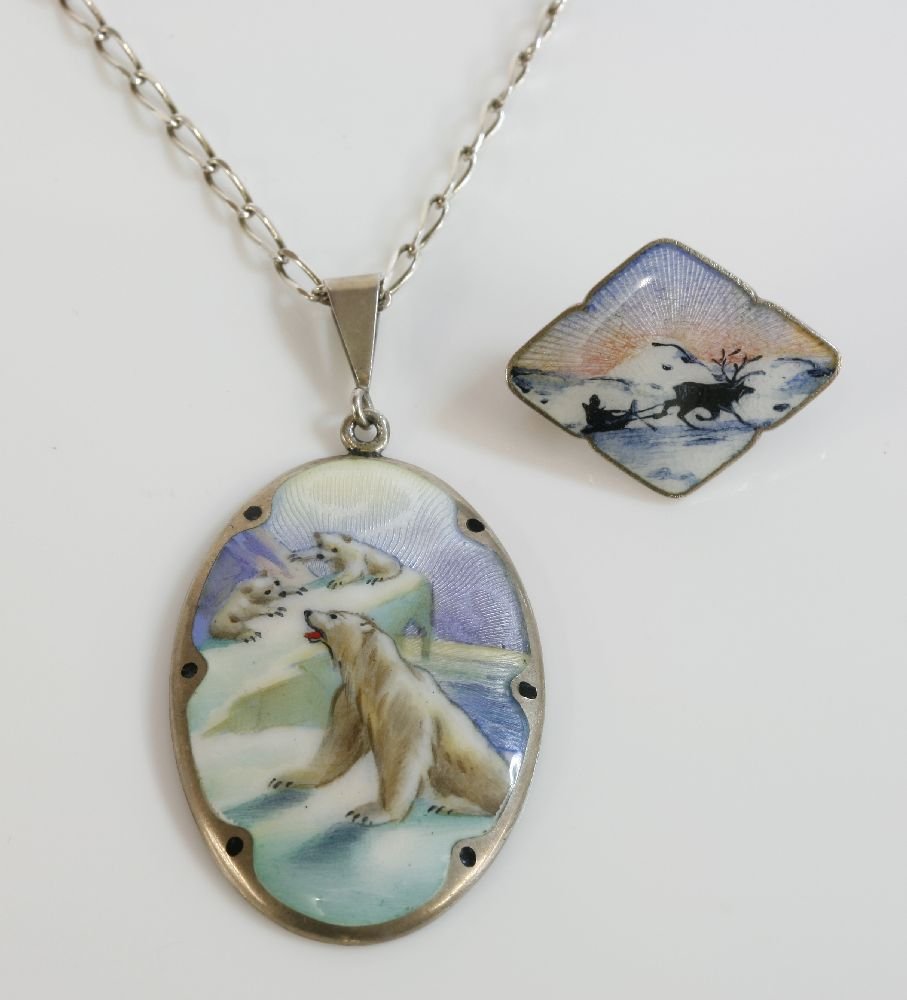 A Norwegian sterling silver enamel pendant, by Gustav: A Norwegian sterling silver enamel pendant, by Gustav Hellstrom of Stavanger 1868-1957, an oval plaque with polychrome guilloch‚ enamel decoration, depicting polar bears on the ice to a black dot bo