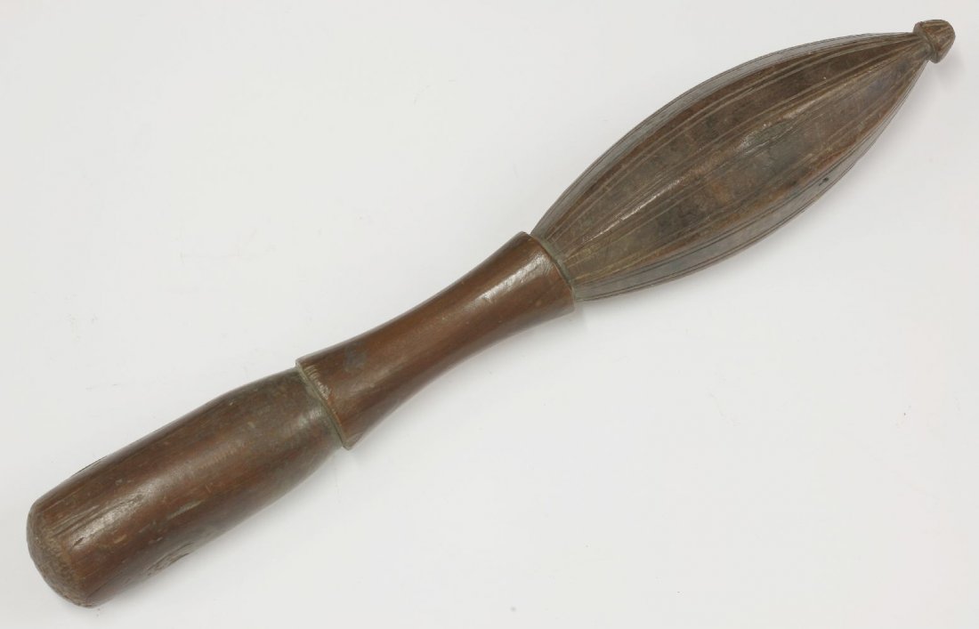 An unusual Polynesian hardwood pestle, waisted with: An unusual Polynesian hardwood pestle, waisted with scored linear decoration, 53cm long