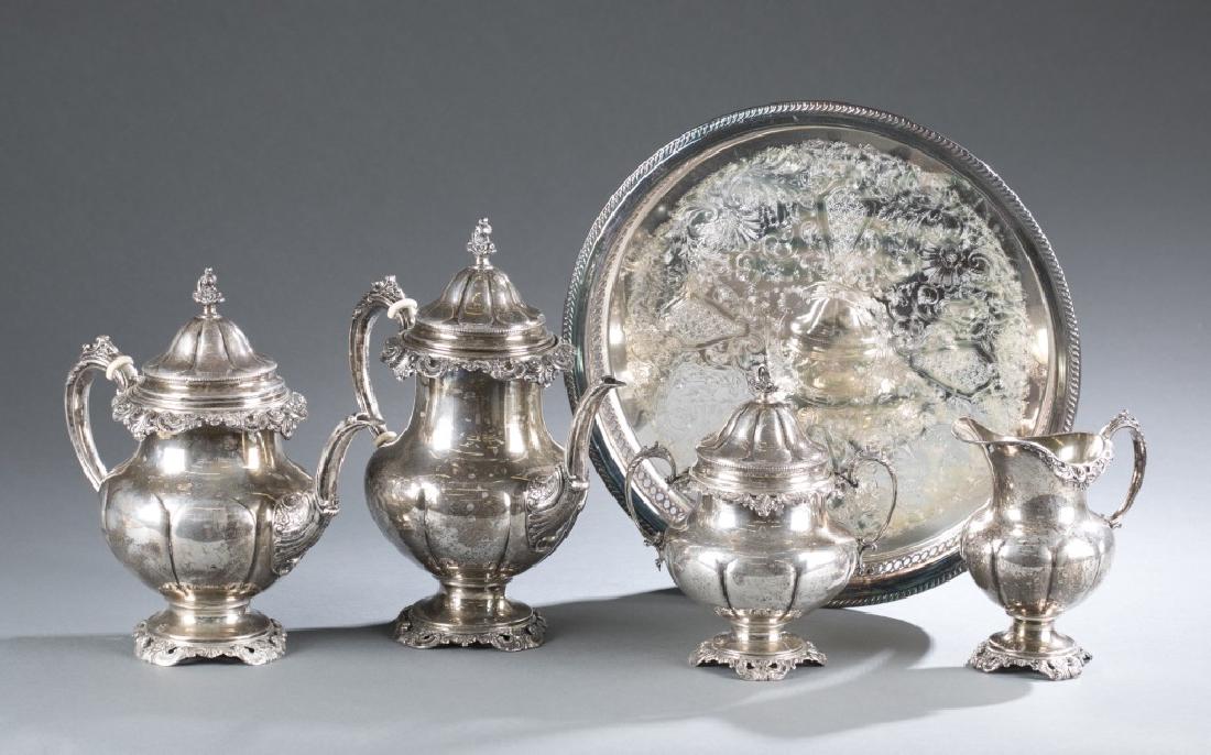 Wallace Sterling tea service w/ tray. 20th century: A Wallace Silversmiths INC (Willingford CT, 1834-1984) four piece tea service. c. 20th century. Set includes tea pot (9 1/8"), coffee pot (10 1/2"), covered sugar bowl, (7 1/2"), and creamer (6"). Mar