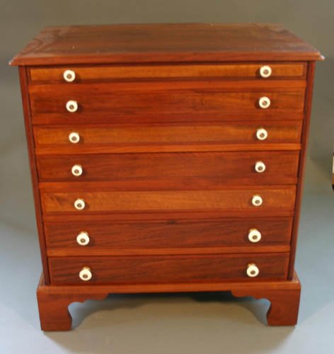 Walnut spool cabinet with 7 drawers, each with