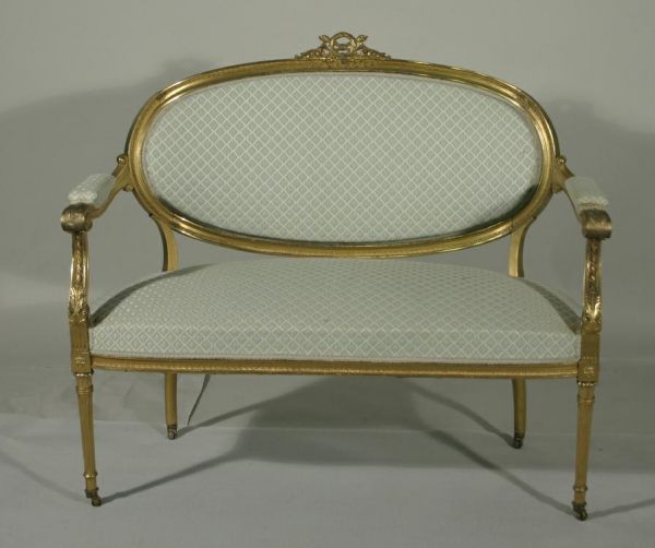 A Louis XVI style gilt wood parlor set - settee, a: A Louis XVI style gilt wood parlor set - settee, arm chair, side chair with wreath & brazier crests, acanthus arm supports, terminating in fluted legs with casters, some seams coming loose, late 19th