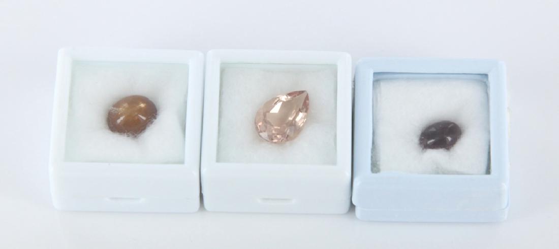 Group of 3 loose stones, cat's eye & morganite.: A group of 3 loose stones. ++ Oval cat's eye sunstone. 8.7 x 6.1mm. ++ Oval 3.9 ctw. cat's eye sunstone, 10.1 x 8.6mm ++ Tear drop 4.83 ctw natural morganite, 13 x 9mm.