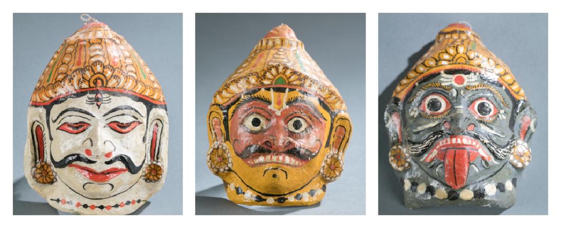 3 Indonesian style polychrome masks. c.20th cen.: A group of three Indonesian style polychrome masks.++ 7 1/8" x 5 1/2" x 2 3/4" ++ 6" x 4 3/4" x 2 1/8".