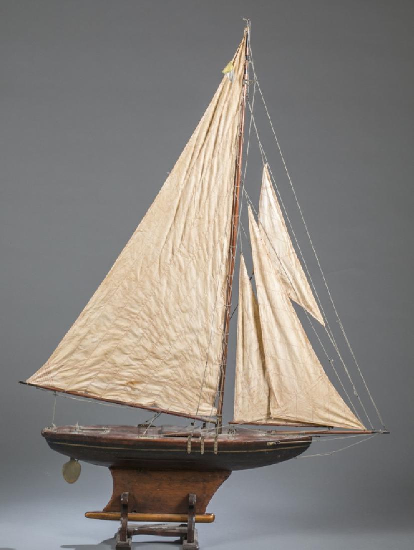 Early 20th century large painted pond boat.: An early 20th century large painted model pond boat. 5'9" x 49". Condition: Pieces of the sail are not attached. condition in fair.