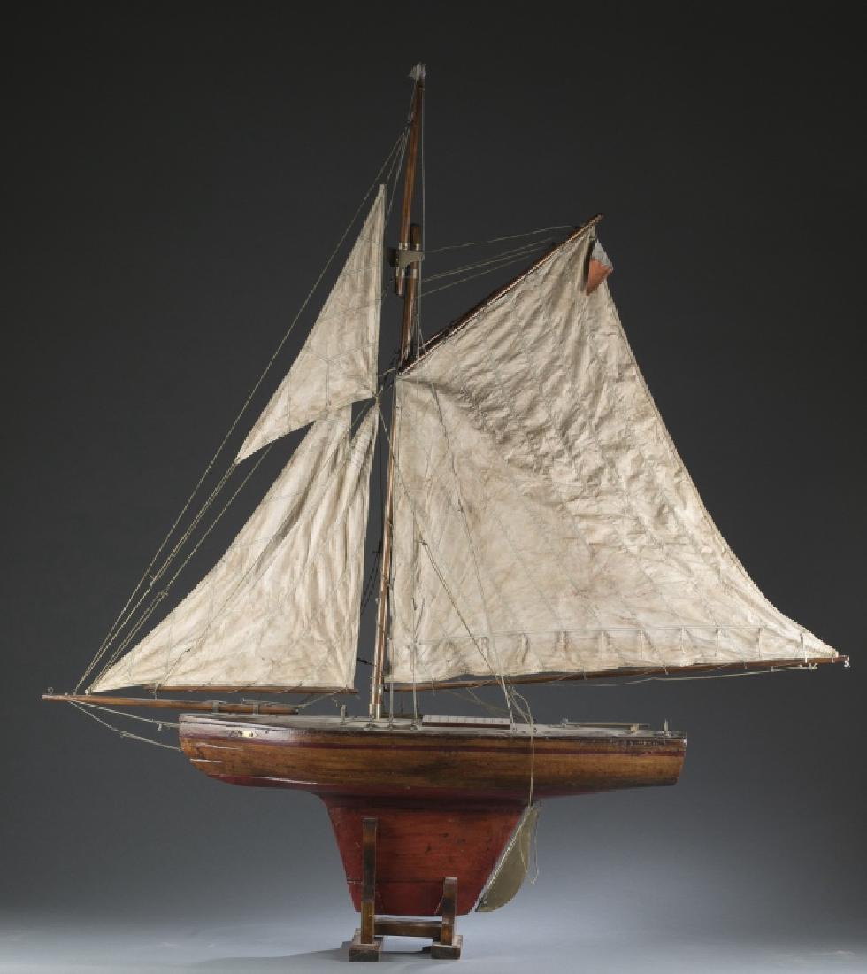 Early 20th century large pond boat on stand.: A large painted wooden pond boat on stand. Early 20th century. 4' 2" x 37". Condition: Pieces of the sail are not attached. condition in fair.