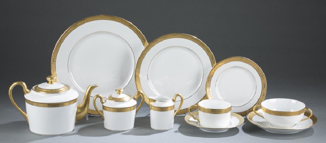 Limoges Raynaud partial dinner service.: A Limoges Raynaud partial dinner service with gilded handles and a patterned gold band on edges. Comprising of 12 dinner plates 11" diam.,12 luncheon plates 9" diam., 12 bread plates 6 1/2" diam., 12 