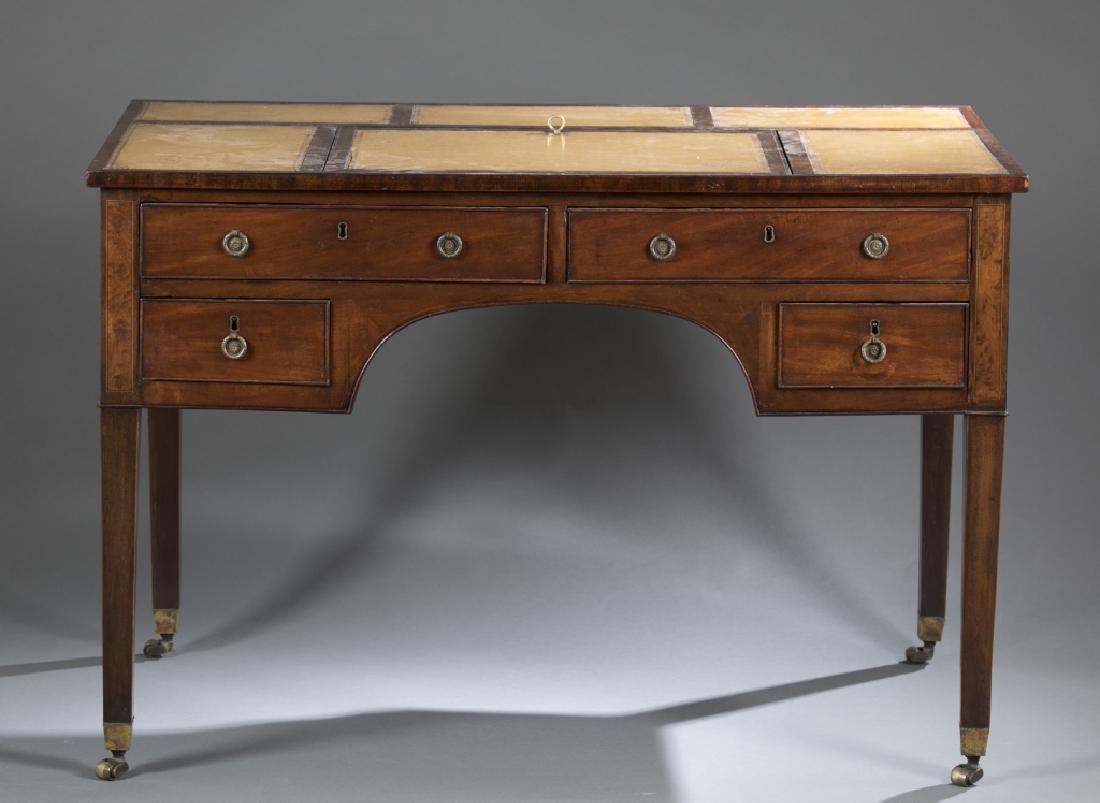 English style mahogany embossed leather desk.: An English Hepplewhite style embossed leather desk in mahogany. Featuring a paneled leather writing surface where the middle panel is adjustable for desired height, four drawers with brass wreath pull